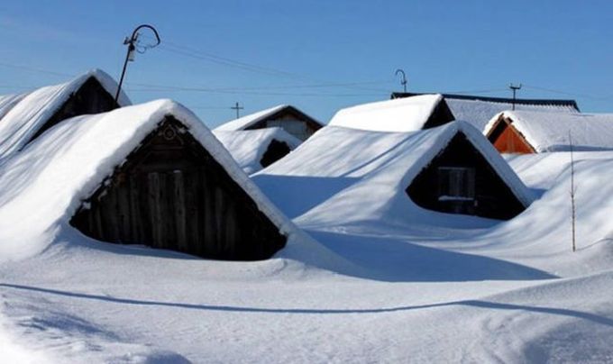 roof tops peaking out of snow
