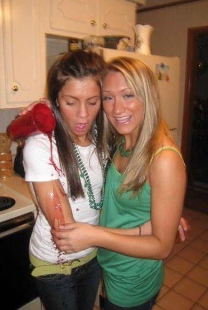 drunk girl pours drink for her friend on her arm