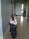 little girl hugging huge gun, wtf