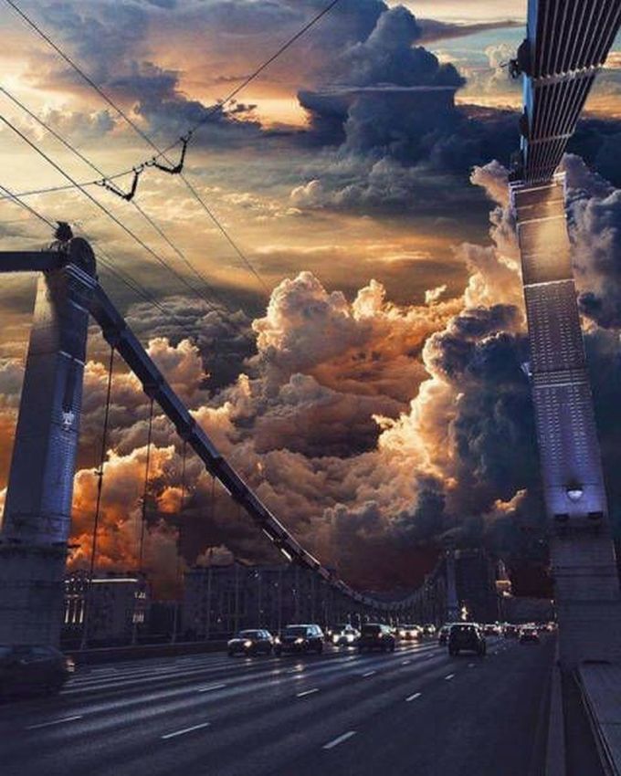 crazy clouds over city bridge