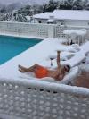 getting a tan in the winter, poolside with snow, wtf