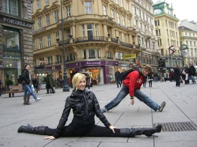 homeless guy tries to imitate splits done by blond in town square