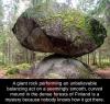 a giant rock performing an unbelievable balancing act on a seemingly smooth curved mound in the fence forests of finland, it's a mystery because nobody knows how it got there