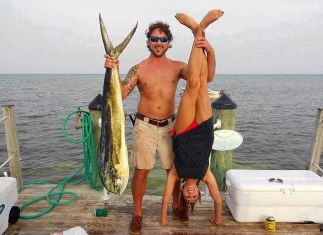 man with two great catches, fish and woman hung upside down