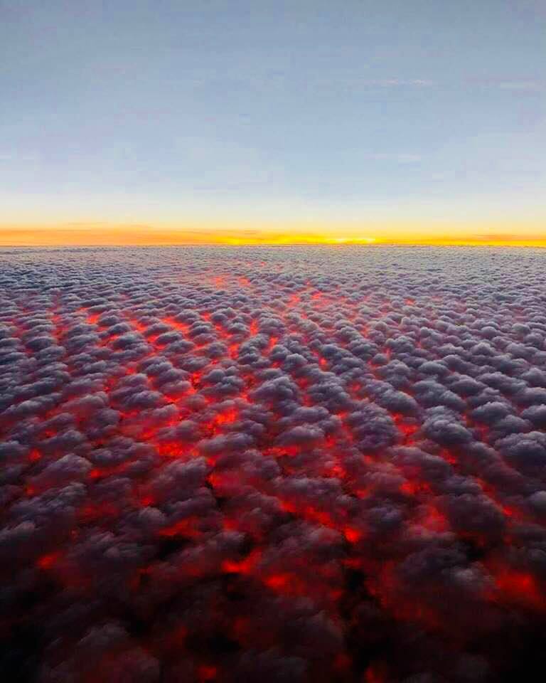 clouds above the california wildfires, this is at 30k feet, that's the sunset on the horizon