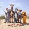 trophy hunter becomes the hunted, animal costumes, naked man in sand