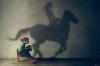 girl on rocking horse and her shadow