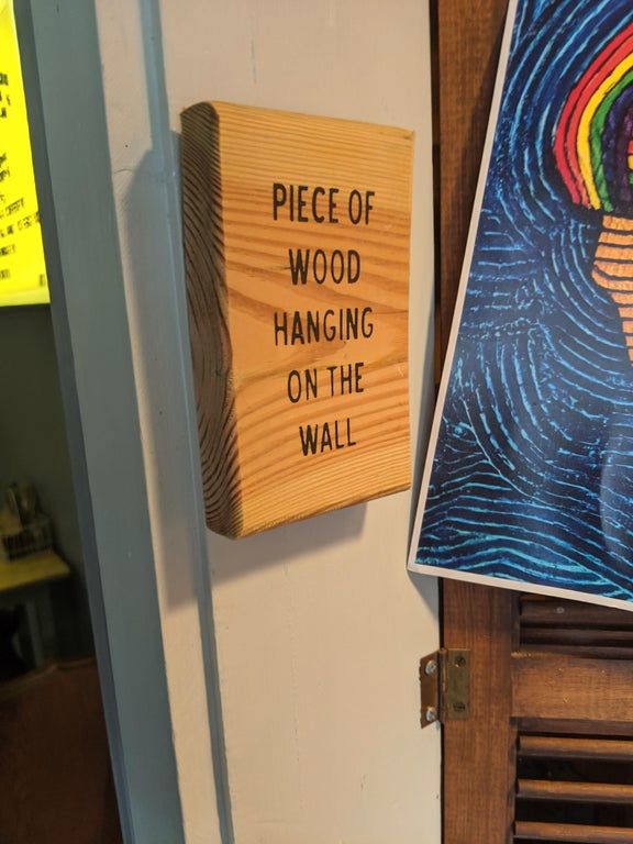 obvious wood is obvious, piece of wood hanging on the wall, wtf