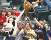 super mom catches baseball while holding baby