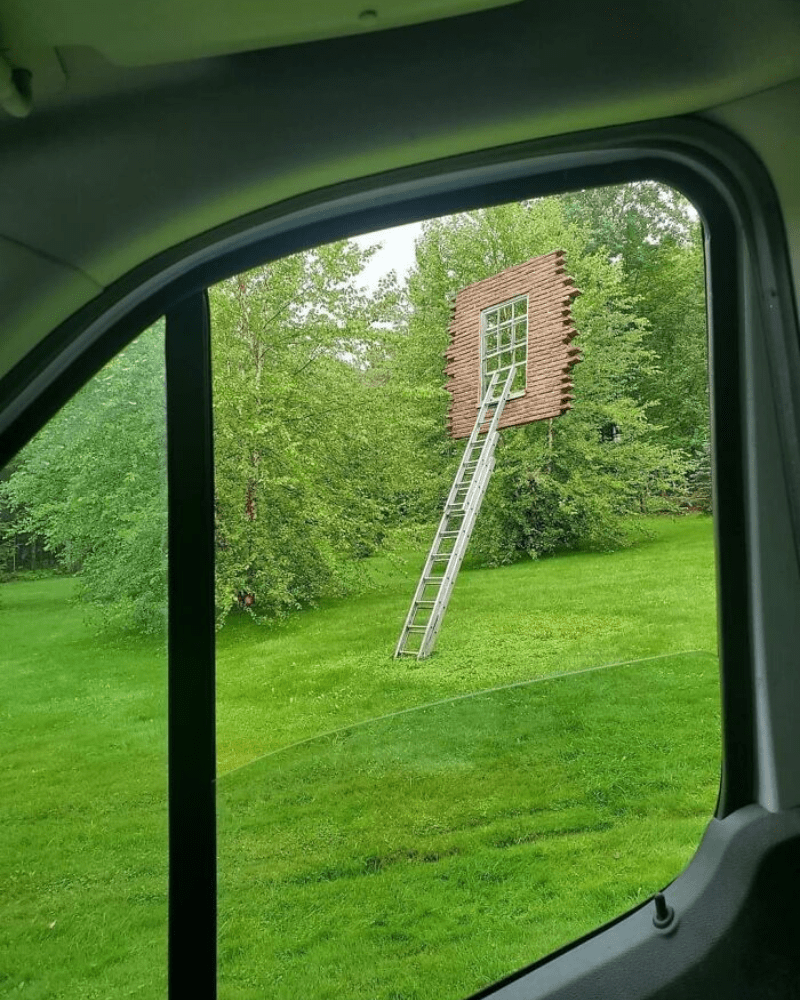 ladder to window in floating brick wall