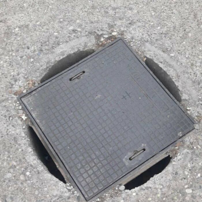worst sewer cover ever, square plate over round hole